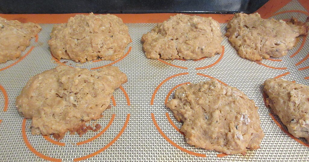 Tray of freshly baked scones, risen and golden, straight out of the oven.
